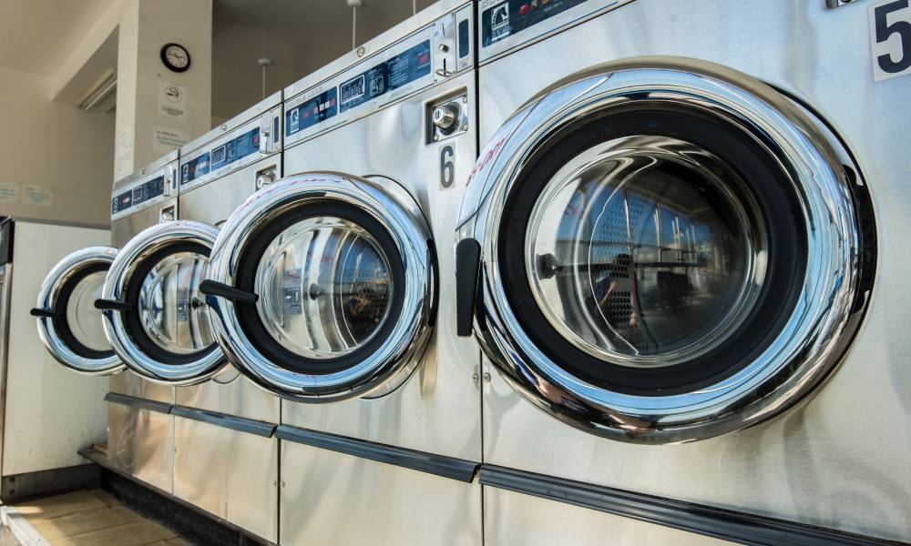 A line of high-efficiency washers at your local laundromat is more economically friendly than you may think.
